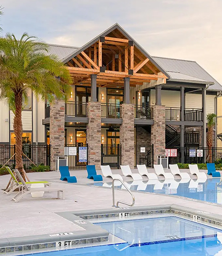 Resort style pool surrounded by lounge chairs